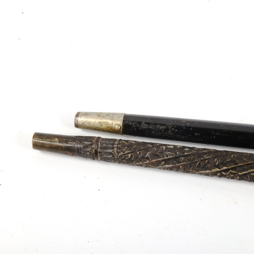 1067 - A 19th century walking stick, with unmarked white metal floral decorated handle, and a relief carved... 