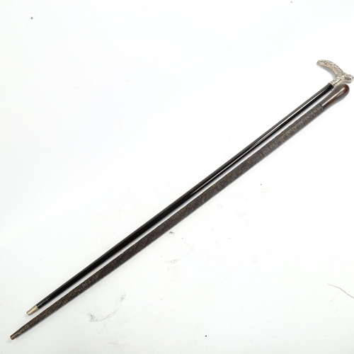 1067 - A 19th century walking stick, with unmarked white metal floral decorated handle, and a relief carved... 