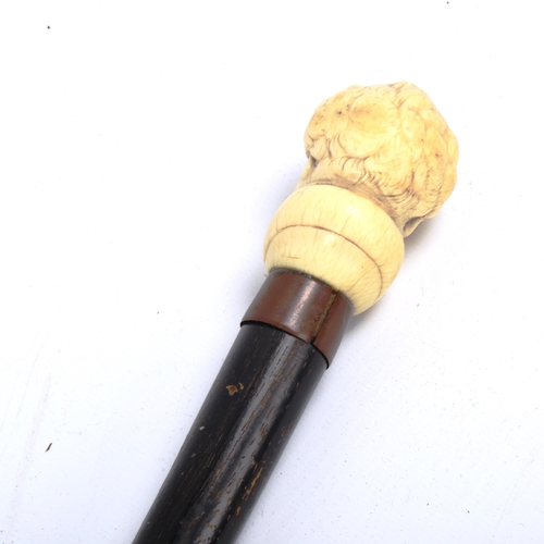1069 - A carved ivory-handled walking cane, depicting the head of a man