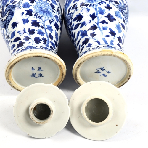 1101 - A pair of 19th century Chinese blue and white porcelain jars and covers with dragon decoration, 4 ch... 