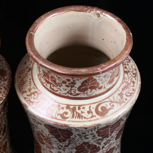1111 - 2 similar Hispano Moresque pottery Albarella drug jars, with painted copper lustre leaf designs, hei... 