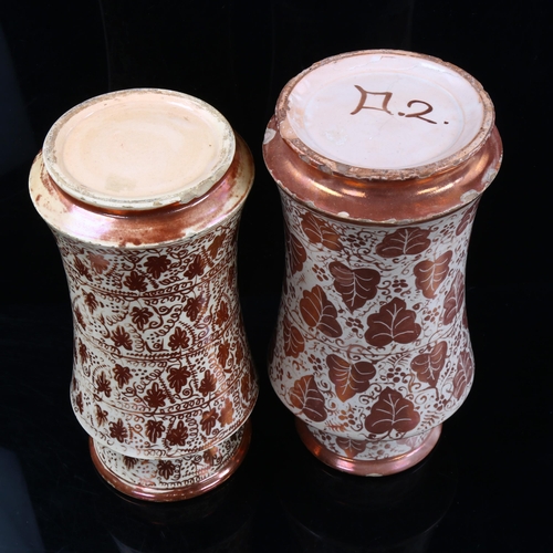 1111 - 2 similar Hispano Moresque pottery Albarella drug jars, with painted copper lustre leaf designs, hei... 