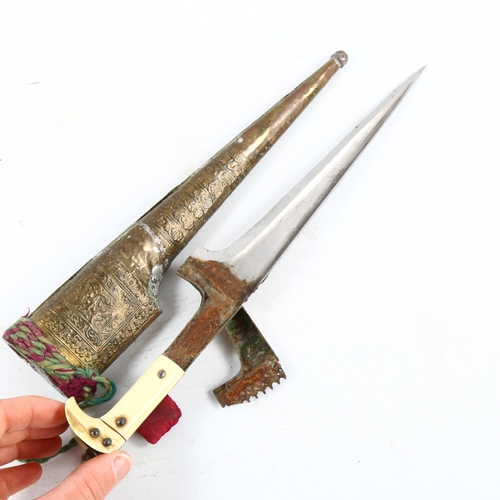 1358 - A Middle Eastern ivory-handled knife, with embossed metal scabbard, length 31cm