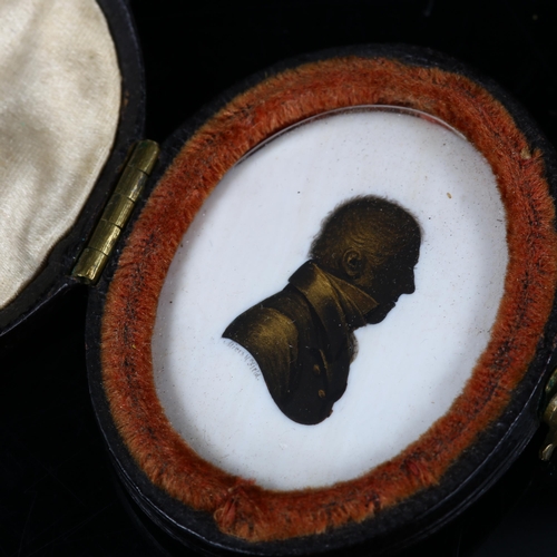1363 - A miniature gilded silhouette portrait of a gentleman, by Miers & Field, in original leather case, c... 