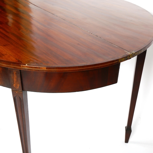 1073 - A George III mahogany demilune fold over tea table, width 91cm