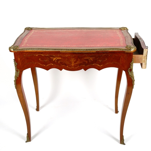 1076 - A French marquetry inlaid kingwood writing table, circa 1900, with serpentine-shaped surround, inset... 