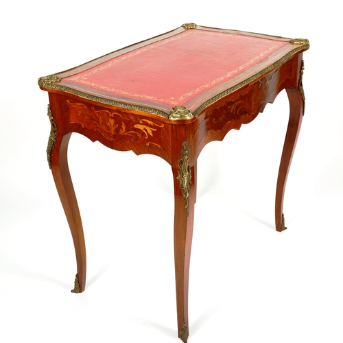 1076 - A French marquetry inlaid kingwood writing table, circa 1900, with serpentine-shaped surround, inset... 