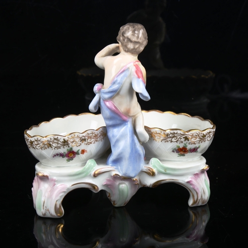 1033 - KPM porcelain table salt surmounted by a putti figure, height 12cm