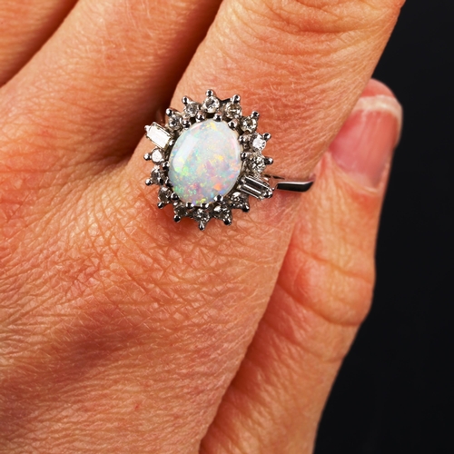 209 - A late 20th century 18ct white gold opal and diamond cluster ring, set with oval cabochon opal and b... 