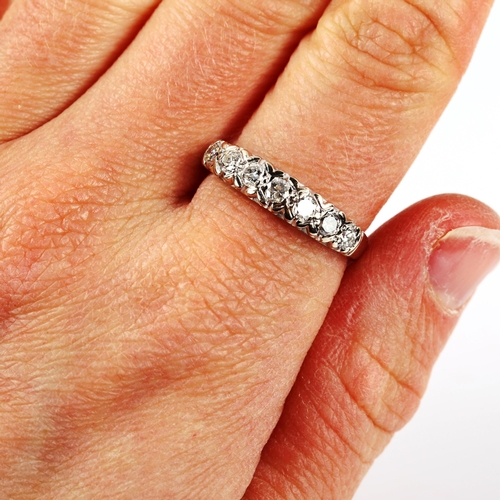 212 - An 18ct white gold seven stone diamond half eternity ring, set with modern round brilliant-cut diamo... 