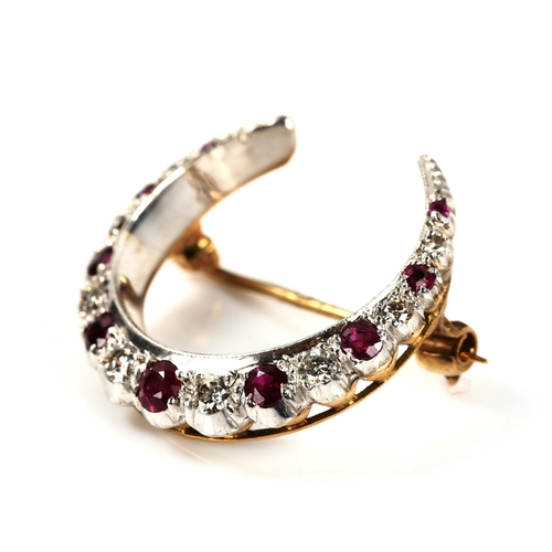 214 - A late 20th century 9ct gold ruby and diamond crescent brooch, set with round-cut stones, total diam... 