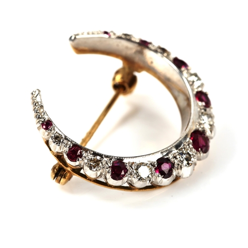 214 - A late 20th century 9ct gold ruby and diamond crescent brooch, set with round-cut stones, total diam... 