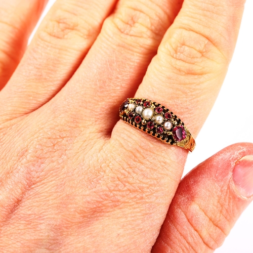 215 - A Victorian 15ct gold ruby and pearl half hoop ring, foliate engraved shoulders with closed-back set... 