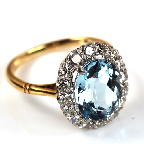 229 - An 18ct gold aquamarine and diamond oval cluster ring, set with oval mixed-cut aqua and single-cut d... 