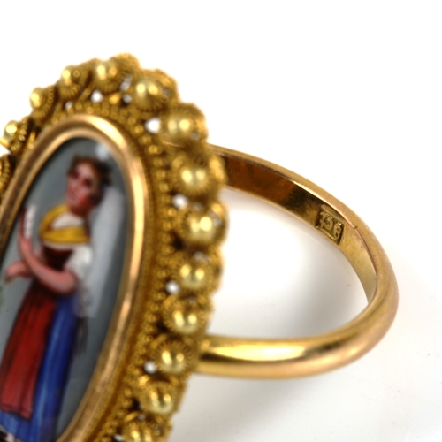 234 - An Antique 9ct gold miniature hand painted enamel panel ring, depicting lady with book, within canne... 