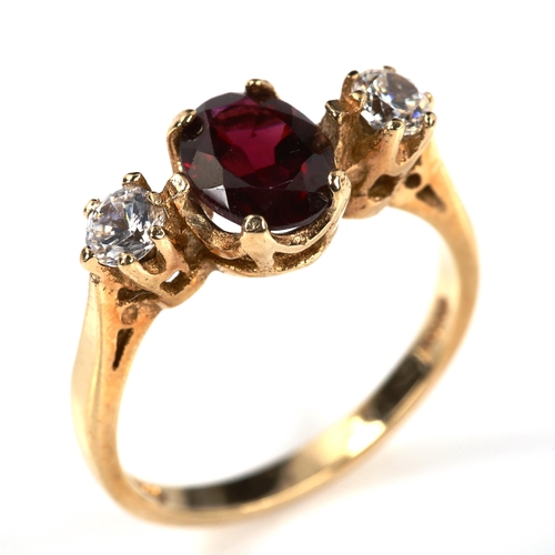 237 - A 9ct gold three stone garnet and cubic zirconia ring, setting height 8mm, size M, 2.8g