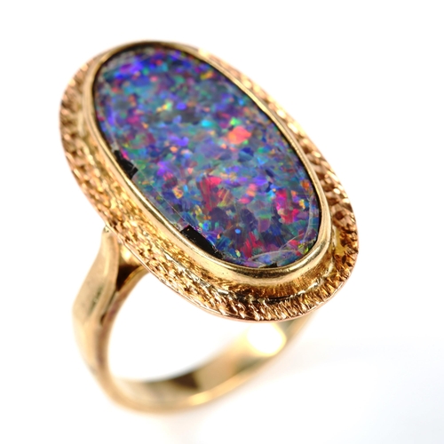 240 - A 9ct gold black opal doublet panel ring, textured surround, setting height 25.2mm, size L, 5.1g