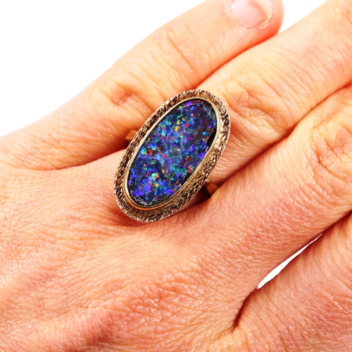 240 - A 9ct gold black opal doublet panel ring, textured surround, setting height 25.2mm, size L, 5.1g