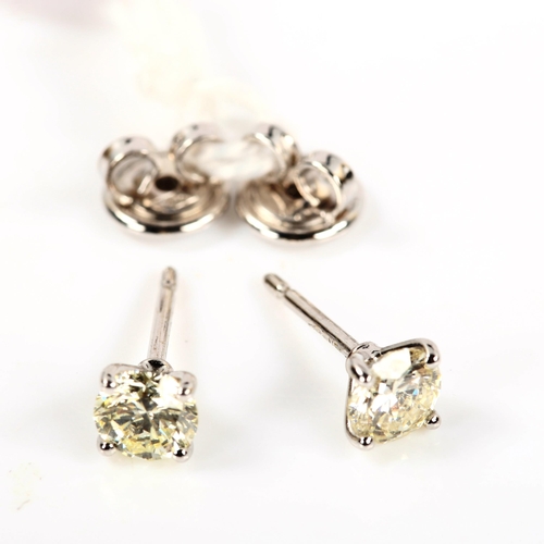 246 - A pair of 18ct white gold 1.01ct solitaire diamond stud earrings, plain 4-claw setting with modern r... 