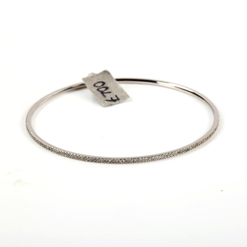 257 - A modern 9ct white gold diamond slave bangle, set with single-cut diamonds, total diamond content ap... 