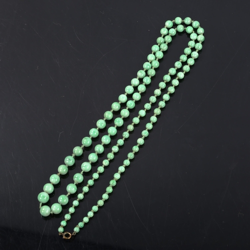 261 - A single-strand graduated jade bead necklace, individually knotted, bead diameters 8.7mm - 4.5mm, ne... 