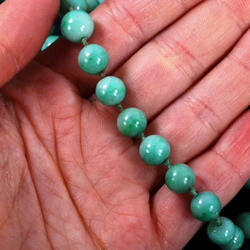 261 - A single-strand graduated jade bead necklace, individually knotted, bead diameters 8.7mm - 4.5mm, ne... 