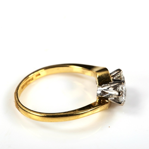 279 - An 18ct gold two stone diamond crossover ring, set with modern round brilliant-cut diamonds, total d... 