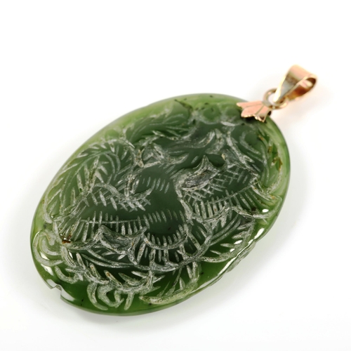 305 - A 14ct gold-mounted jade pendant, carved bird and dragon decoration, pendant height 50.3mm, 10.6g