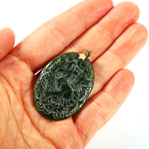 305 - A 14ct gold-mounted jade pendant, carved bird and dragon decoration, pendant height 50.3mm, 10.6g