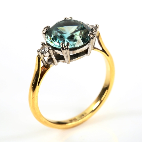 309 - A three stone blue zircon and diamond dress ring, unmarked yellow metal settings, size M, 4g