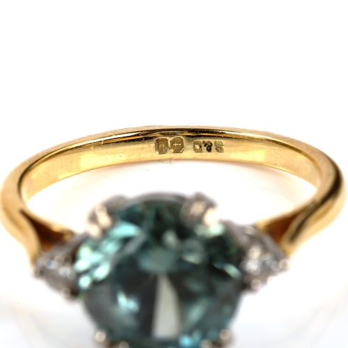 309 - A three stone blue zircon and diamond dress ring, unmarked yellow metal settings, size M, 4g