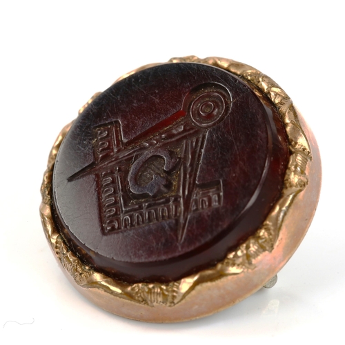 310 - A small Masonic seal fob brooch, intaglio carved with gold plated frame, diameter 21mm, 4.8g (lackin... 