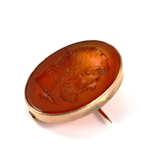 314 - An Antique carnelian seal fob brooch, intaglio carved with male head profile, in unmarked gold frame... 