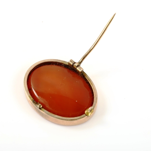 314 - An Antique carnelian seal fob brooch, intaglio carved with male head profile, in unmarked gold frame... 