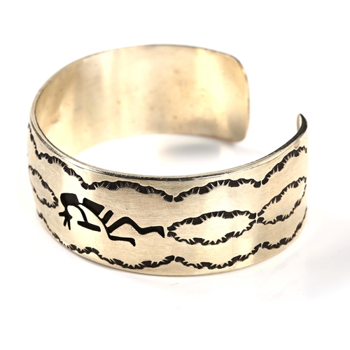 322 - A stylised sterling silver cuff bangle, maker's marks JAC, Native American depicting Kokopelli - fer... 