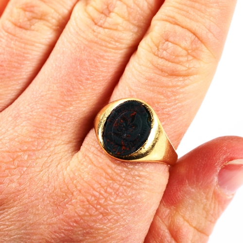 332 - An early 20th century 18ct gold bloodstone seal signet ring, intaglio carved with fleur de lis and g... 