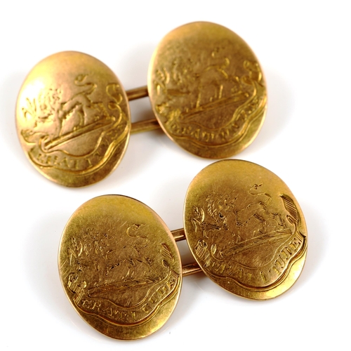 336 - A pair of early 20th century 15ct gold oval cufflinks, engraved with rampant lion emblem and motto 