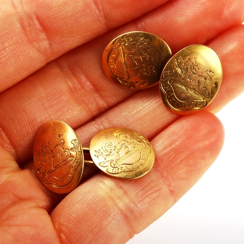 336 - A pair of early 20th century 15ct gold oval cufflinks, engraved with rampant lion emblem and motto 