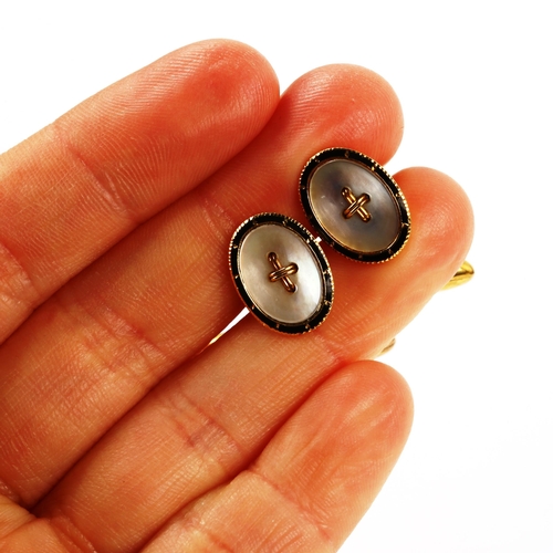 343 - A pair of early 20th century 18ct gold mother-of-pearl and black enamel button cufflinks, with torpe... 