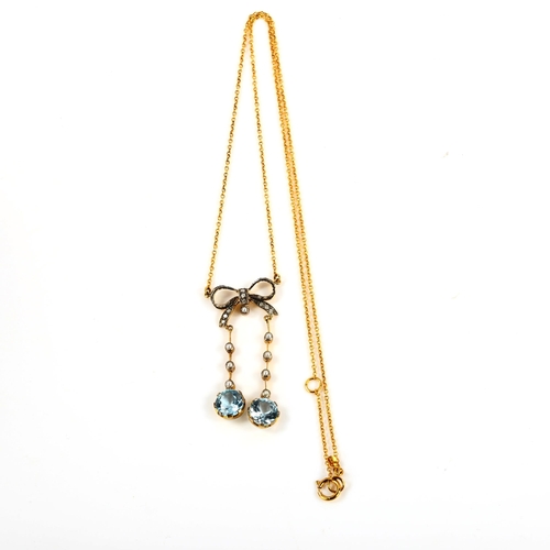 370 - A 9ct gold blue topaz pearl and diamond bow negligee pendant necklace, in Edwardian style, on 9ct fi... 