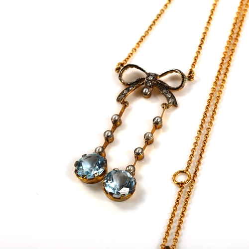 370 - A 9ct gold blue topaz pearl and diamond bow negligee pendant necklace, in Edwardian style, on 9ct fi... 