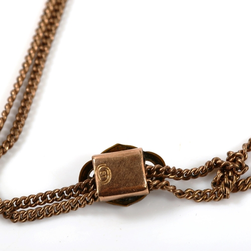 379 - An Antique rose gold plated fine double curb link long guard chain, with stone set slide and dog cli... 