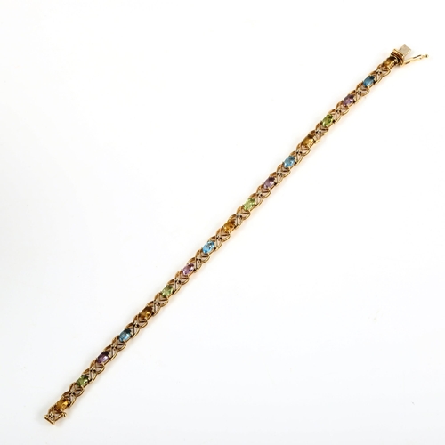 384 - A modern 9ct gold gem set line bracelet, gemstones include citrine peridot amethyst and blue topaz, ... 