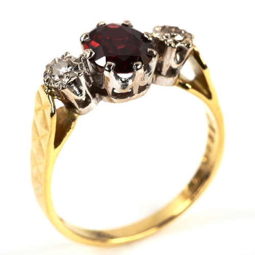 388 - A late 20th century 18ct gold three stone garnet and diamond ring, set with oval mixed-cut garnet an... 