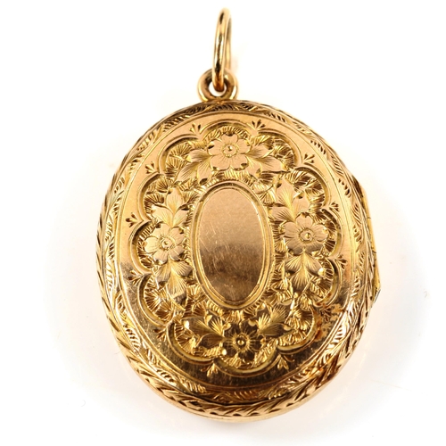 390 - A Victorian 9ct gold oval photo locket pendant, allover engraved floral decoration, pendant height e... 