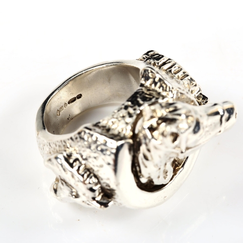 404 - A large and heavy silver horse ring, with horseshoe motif, setting height 31.8mm, size Y, 86.5g