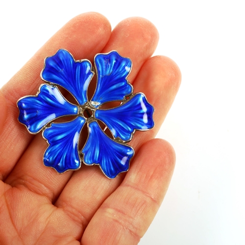 414 - ANDRESEN & SCAEINPFLUG - a Norwegian stylised sterling silver and blue enamel floral brooch, brooch ... 