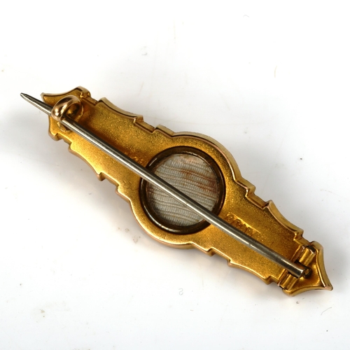 422 - A Victorian 9ct gold Etruscan style memorial brooch, with vacant glass panel back, brooch length 41.... 