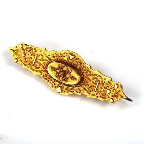 422 - A Victorian 9ct gold Etruscan style memorial brooch, with vacant glass panel back, brooch length 41.... 