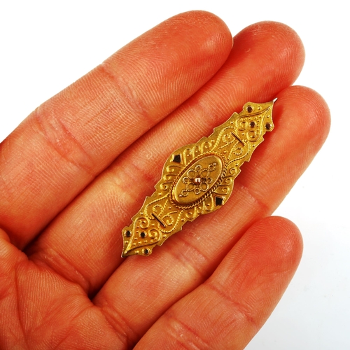 422 - A Victorian 9ct gold Etruscan style memorial brooch, with vacant glass panel back, brooch length 41.... 